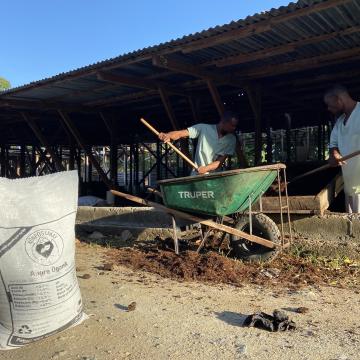 Compost team pictured with SOIL’s organic, agriculture-grade compost made from human waste.