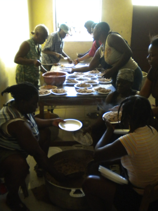 Women preparing food for earthquake victims in Ti Plas Kazo.